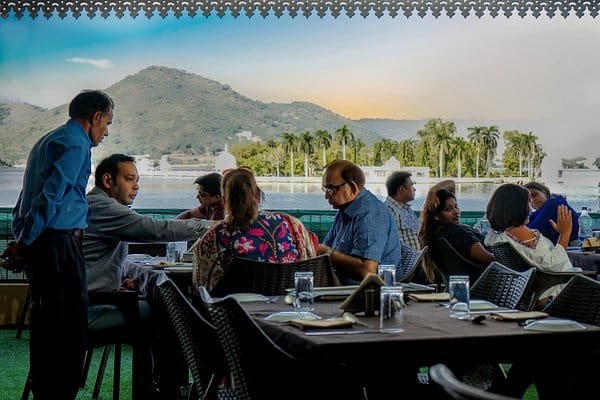 Outdoor dining terrace at Weddings Mine Lake-View Restaurant with guests seated beside the water