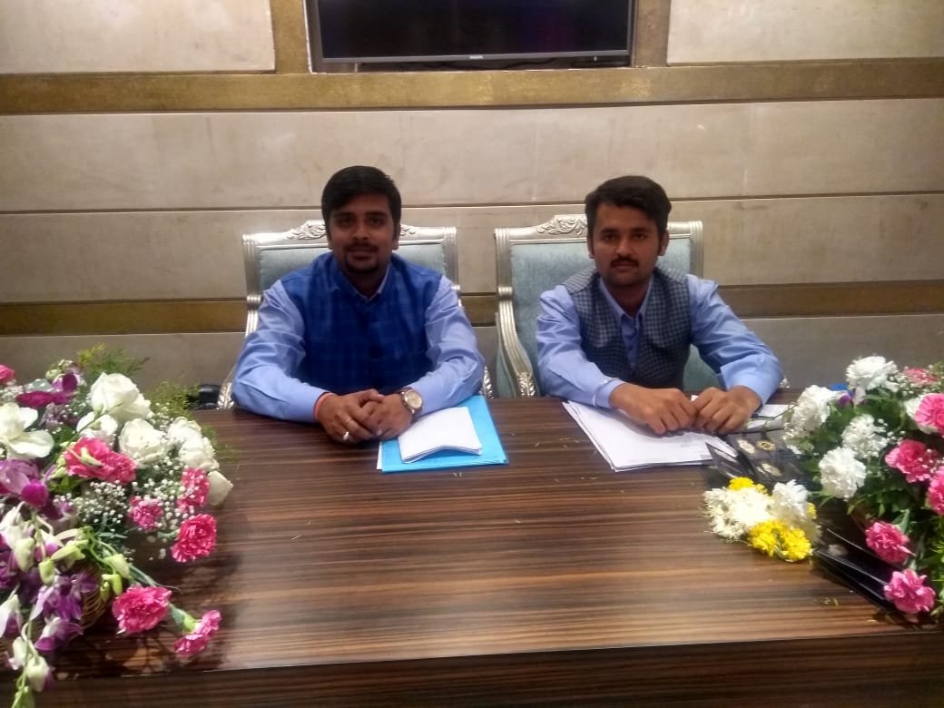 Hospitality coordinators seated at floral desk managing wedding guest logistics