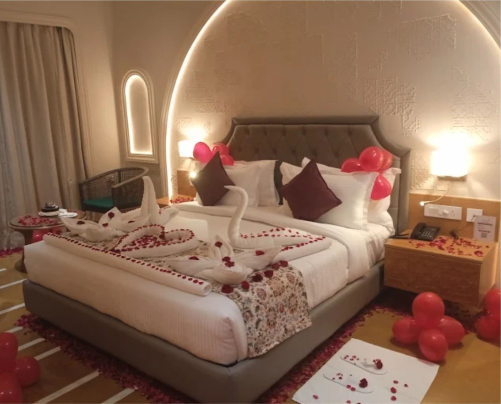 Romantic honeymoon suite with swan towel art in Udaipur