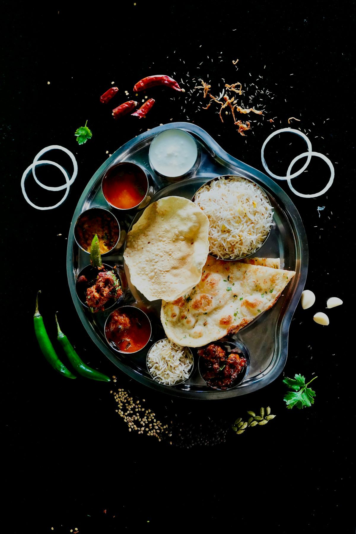Grand Indian Thali platter featuring fragrant basmati rice, bread, and regional curries